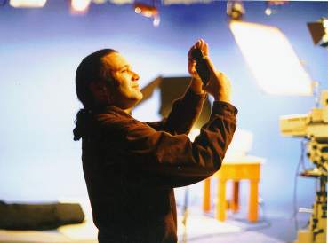 Steven Bradford Holding meter to light, blue cyc stage background