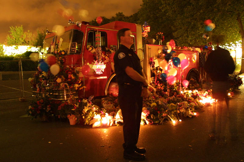 Seattle Fire Department Rig, draped in flowers and candles honoring the fallen firemen