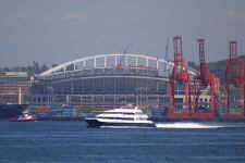 The highspeed passenger ferry is framed by the too new Seahawks stadium