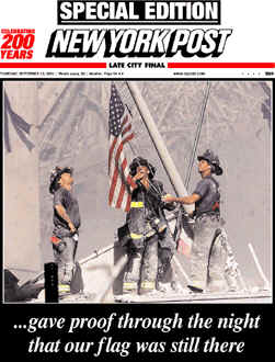 Firemen raise the flag over the fallen wreckage of the World Trade Center, in an historic reminder of Iwo Jima
